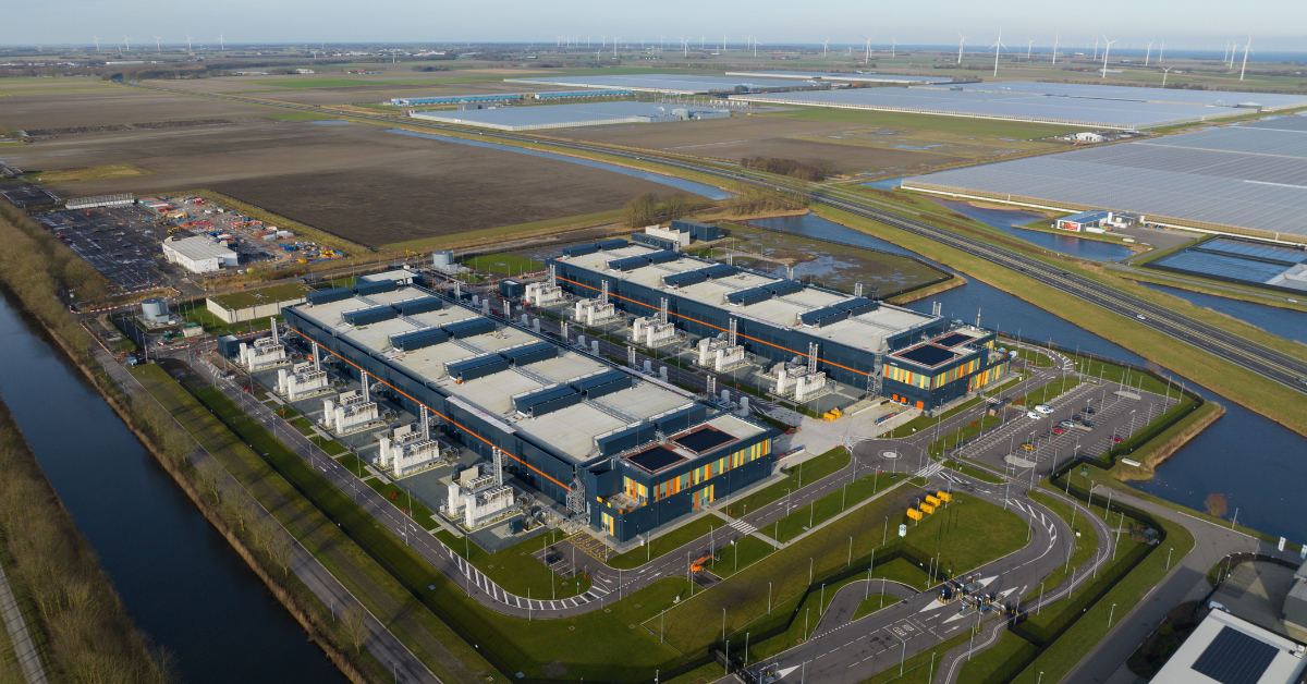 Aerial view of a modern hyperscale data center facility situated on large acreage, illustrating data center site selection and infrastructure readiness.