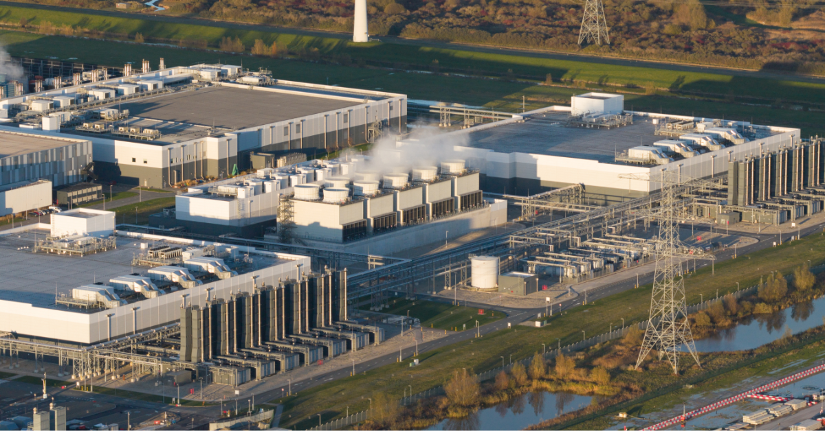 Aerial view of a hyperscale data center campus showing industrial cooling towers and utility infrastructure, illustrating cooling water access and data center water rights.