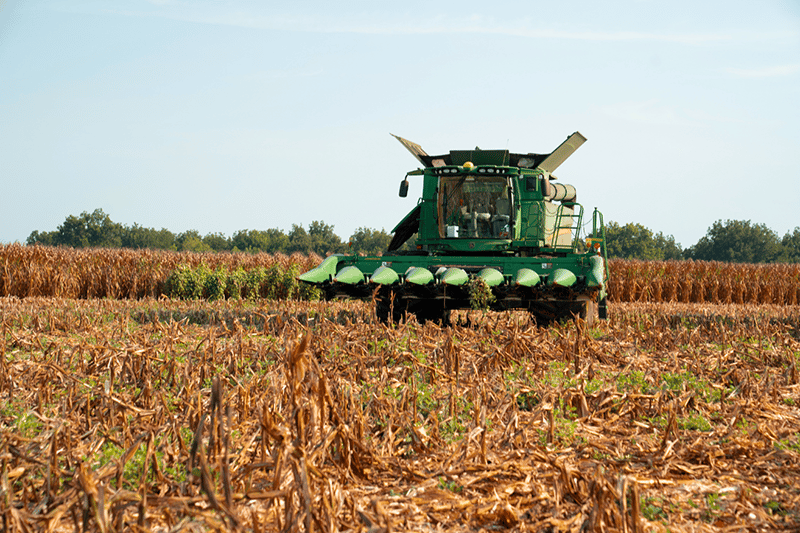 Agricultural tractor in field representing farmland as a major U.S. real estate asset class challenging for AVM accuracy